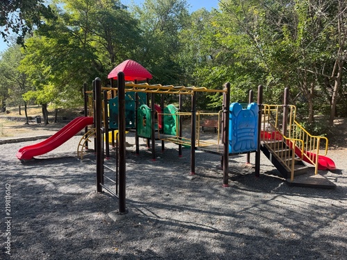 Cuadro en lienzo Colorful children playground equipment with slides and monkey bars in a public p
