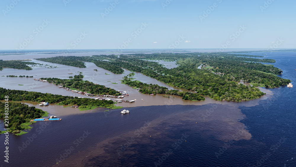 Obraz premium Amazon Meeting Of Waters At Manaus In Amazonas Brazil. Water From Solimoes River And Black River Form The Amazon River Known As Meeting Of Waters. Amazon Meeting Of Waters In Manaus Brazil.