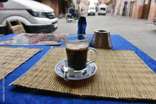 Traditional Moroccan spiced coffee served on a street cafe table in Marrakech