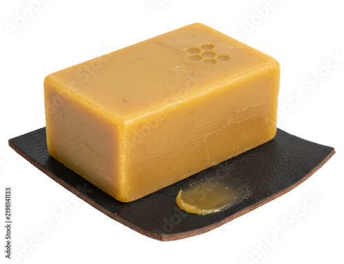 Natural handmade honey soap bar on dark coaster isolated on transparent