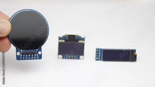 Round display module and rectangular oled modules of different sizes on white background