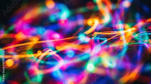 Abstract background featuring a vibrant colorful light effect created with long exposure photography of glowing festive holiday lights
