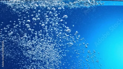 Blue bubbles rise in clear soda with a smooth loop animation for a refreshing background