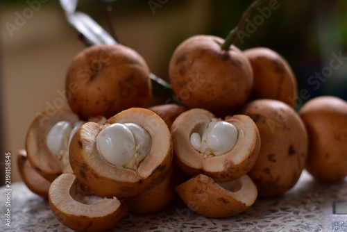fruit is called greater tampoi aka aglaia sp with white fruit content and light brown fruit skin, Baccaurea macrocarpa fruit