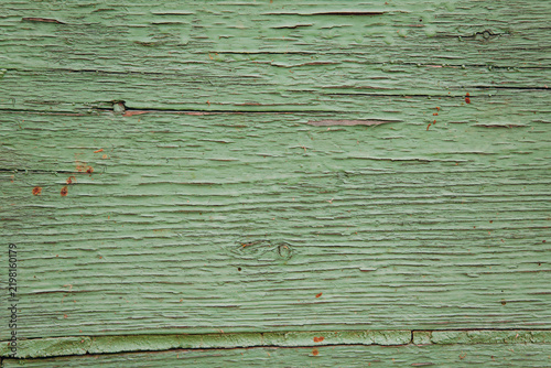 Peeling green paint on old weathered wood background