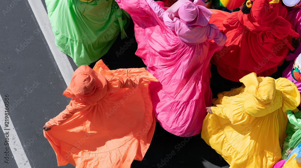 Obraz premium Vibrant Dancers Wearing Colorful Traditional Dresses Participate In The Lively Annual Carnaval de San Miguel Street Parade Celebrating Local Culture