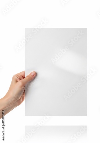 Hand holding blank white paper sheet, isolated on white, for copy space, presentation, document.