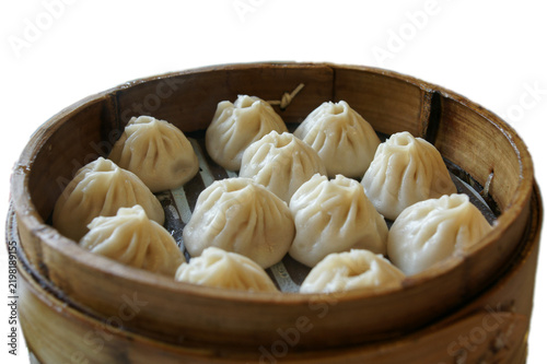 Steamed dumplings served in a traditional bamboo steamer, featuring delicate pleated wrappers and warm Asian culinary presentation on a clean white background.