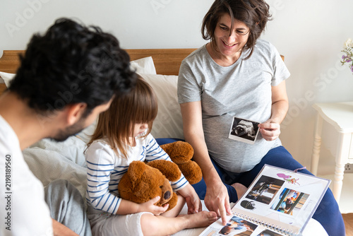 Bild auf Leinwand Family cherishing photo memories together.
