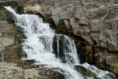 Cascading Waterfall Among Rocky Cliffs