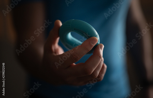 Man Uses Blue Rubber Grip Trainer For Wrist And Forearm Muscle Training