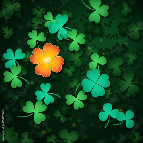 A glowing orange four-leaf clover standing out among green shamrocks representing uniqueness and good luck