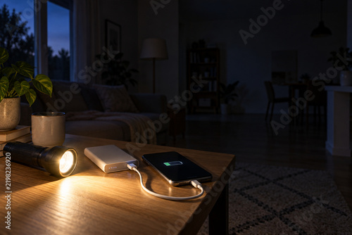 Smartphone Charging with Power Bank and Flashlight During Home Power Outage