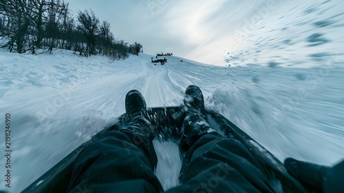 POV Sledding Fast Down Snowy Hill on Plastic Toboggan.