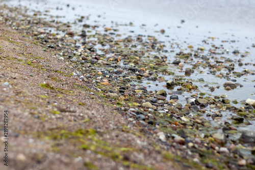 Cuadro en lienzo Pebble Shoreline with Shallow Water Along Coastal Beach