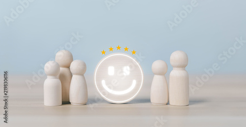 Customer satisfaction concept featuring wooden figures surrounding a smiling five star symbol, representing positive feedback, customer experience, loyalty, service quality, trust, business reputation