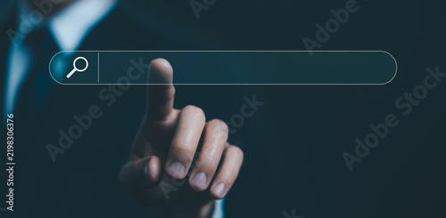 Businessman touching a digital search bar interface. representing online search, web browsing, information discovery, digital technology, internet research, navigation, and modern business.