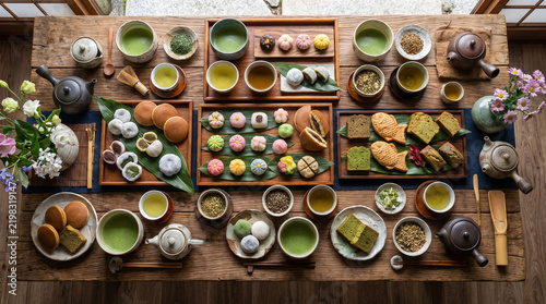 Wide-angle shot of a full Overhead shot of tea varieties with dessert