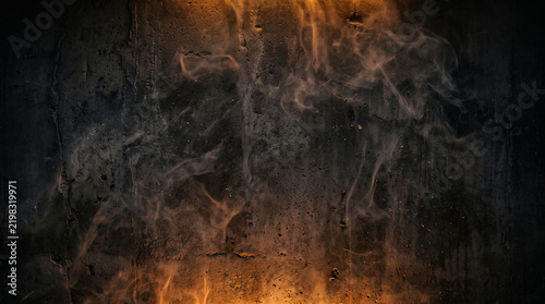 Atmospheric dark textured concrete background with subtle wisps of smoke and orange amber backlight, perfect for Halloween text overlay