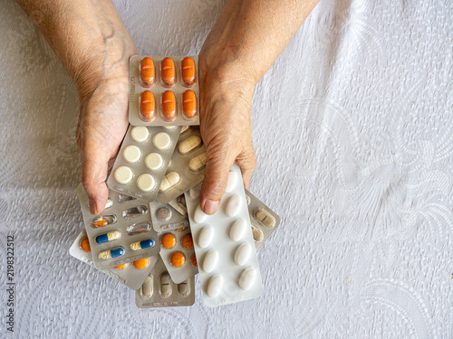 Senior Woman Hands Holding Multiple Medication Blister Packs at Home