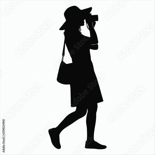 Silhouette of a Woman Photographer with a Hat and Camera