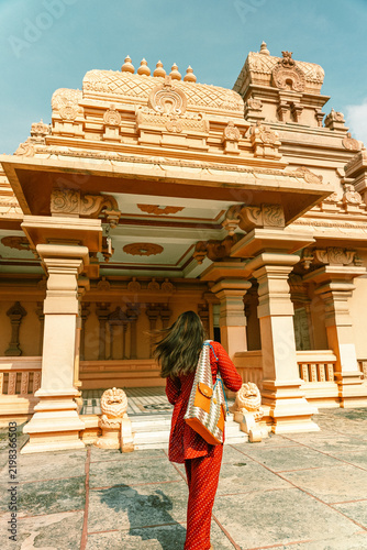 A woman in traditional dress poses for a portrait at Chhatarpur Temple (Shri Adya Katyayani Shakti Peeth Mandir), one of the largest temple complexes in India, in South Delhi.