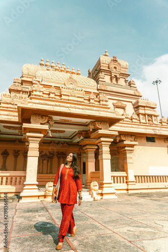 A woman in traditional dress poses for a portrait at Chhatarpur Temple (Shri Adya Katyayani Shakti Peeth Mandir), one of the largest temple complexes in India, in South Delhi.