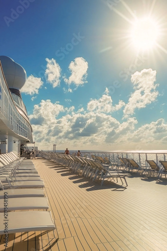 Lounge chairs on the deck of a cruise ship, perfect for relaxation at sea vertical frame