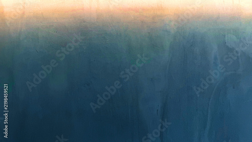 Abstract gradient texture background with warm golden light transitioning to dark blue teal plaster wall finish modern interior surface design copy space.