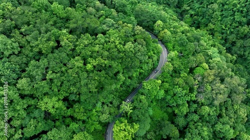 Road in the middle of the forest , road curve construction up to mountain, Aerial view of Rainforest ecosystem and healthy environment concept