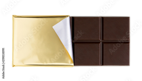 Dark chocolate bar partially unwrapped in gold foil isolated on white