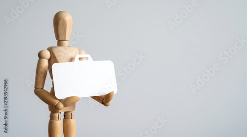 Marketing team mid-year performance review and employee evaluation concept with wooden mannequin holding briefcase cutout and copy space for business presentation banner