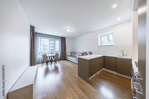 Bright Modern Open-Plan Apartment With Kitchen, Living Room and Dining Area Overlooking City Windows