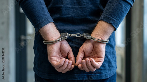Man handcuffed behind back, crime suspect, arrest, justice concept
