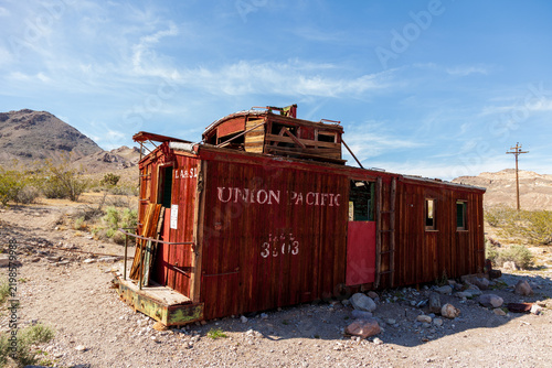Photography Weathered red railway caboose with faded lettering and elevated lookout structur