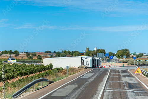 Overturned truck with refrigerated semitrailer on a roundabout