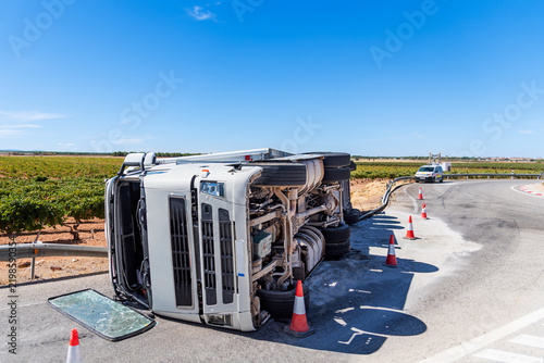 Truck with refrigerated semitrailer overturned in a roundabout