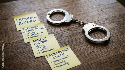 Criminal Record And Arrest History Handcuffs On Wooden Surface