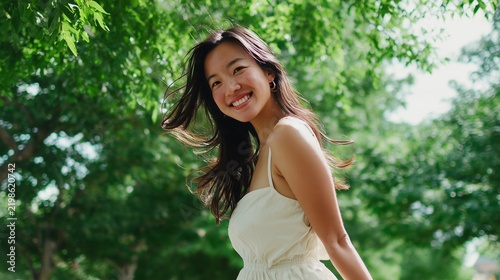 Happy East Asian Woman Enjoying Summer Day in Park
