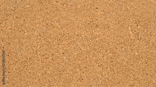 Natural cork board texture background, brown granular bulletin board surface, organic wood grain material for office memo and message board design