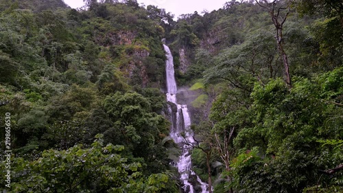 Huai Nam Yen Waterfall cascading through lush tropical rainforest in the rainy season in Omkoi District Chiang Mai, Thailand