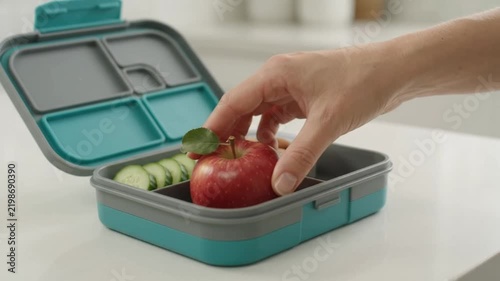 Fresh Red Apple Packed in Reusable Lunch Box for Healthy Snack