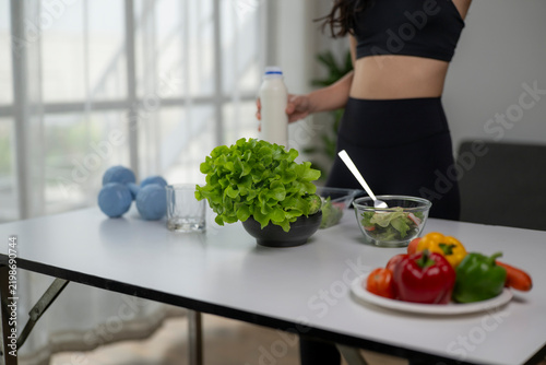 Woman preparing healthy salad for fitness lifestyle and nutrition