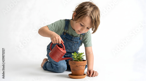 Young child with watering can tending to potted plant in bright studio setting with clean white background