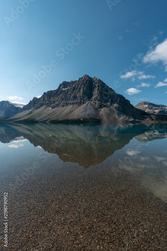 Crowfoot Mountain rises above the turquoise water of Bow Lake on the Icefields Parkway in Banff National Park, Alberta