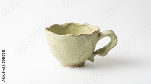 Title: Minimal white ceramic tea cup isolated on white background representing elegant tableware, tea culture, modern kitchen accessories, cozy lifestyle, and beverage presentation