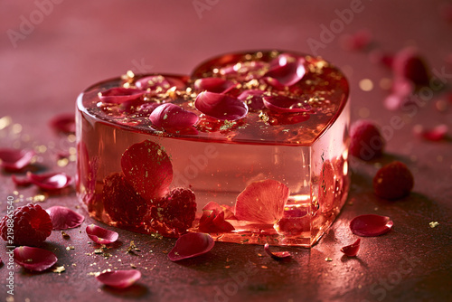 Heart-shaped raspberry mousse with petals and gold details