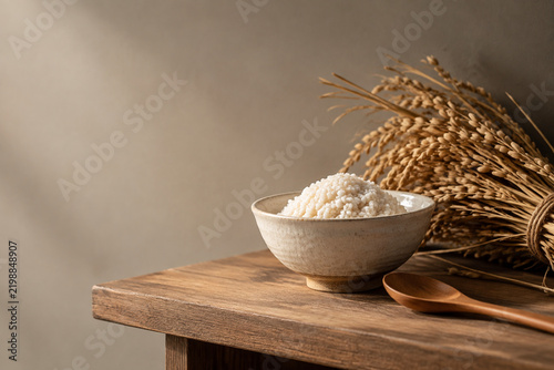 Ceramic bowl of koji rice on wooden shelf with rice straw, traditional ingredient concept