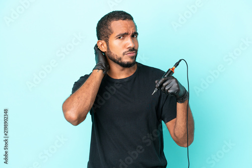 Photography Tattoo artist Ecuadorian man isolated on blue background having doubts