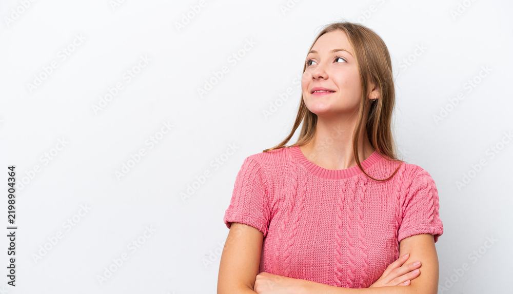 Fototapeta premium Young Russian woman isolated on white background looking up while smiling